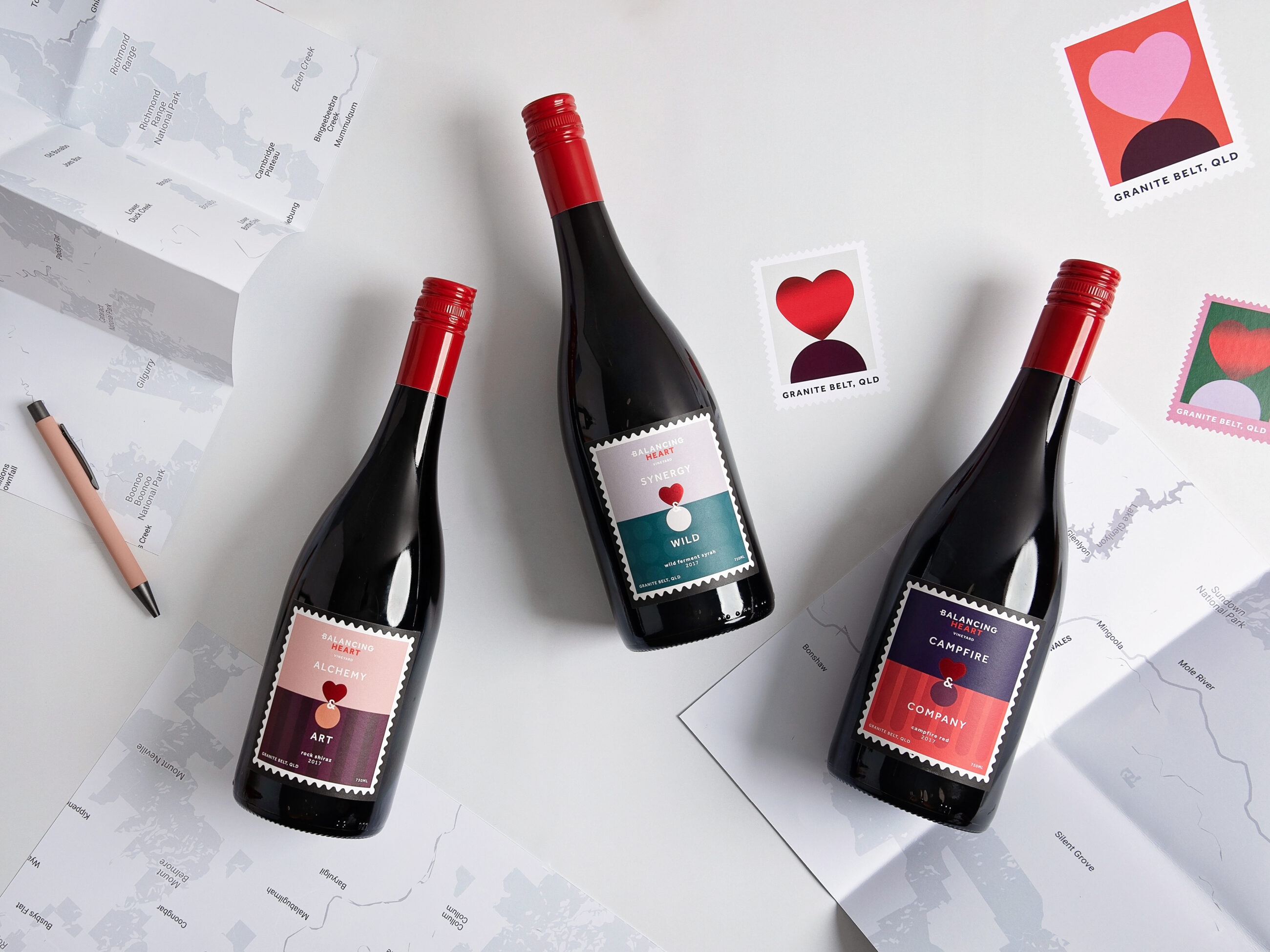 Creative photoshoot of three bottles of Balancing Heart wine, connecting brands and communities
