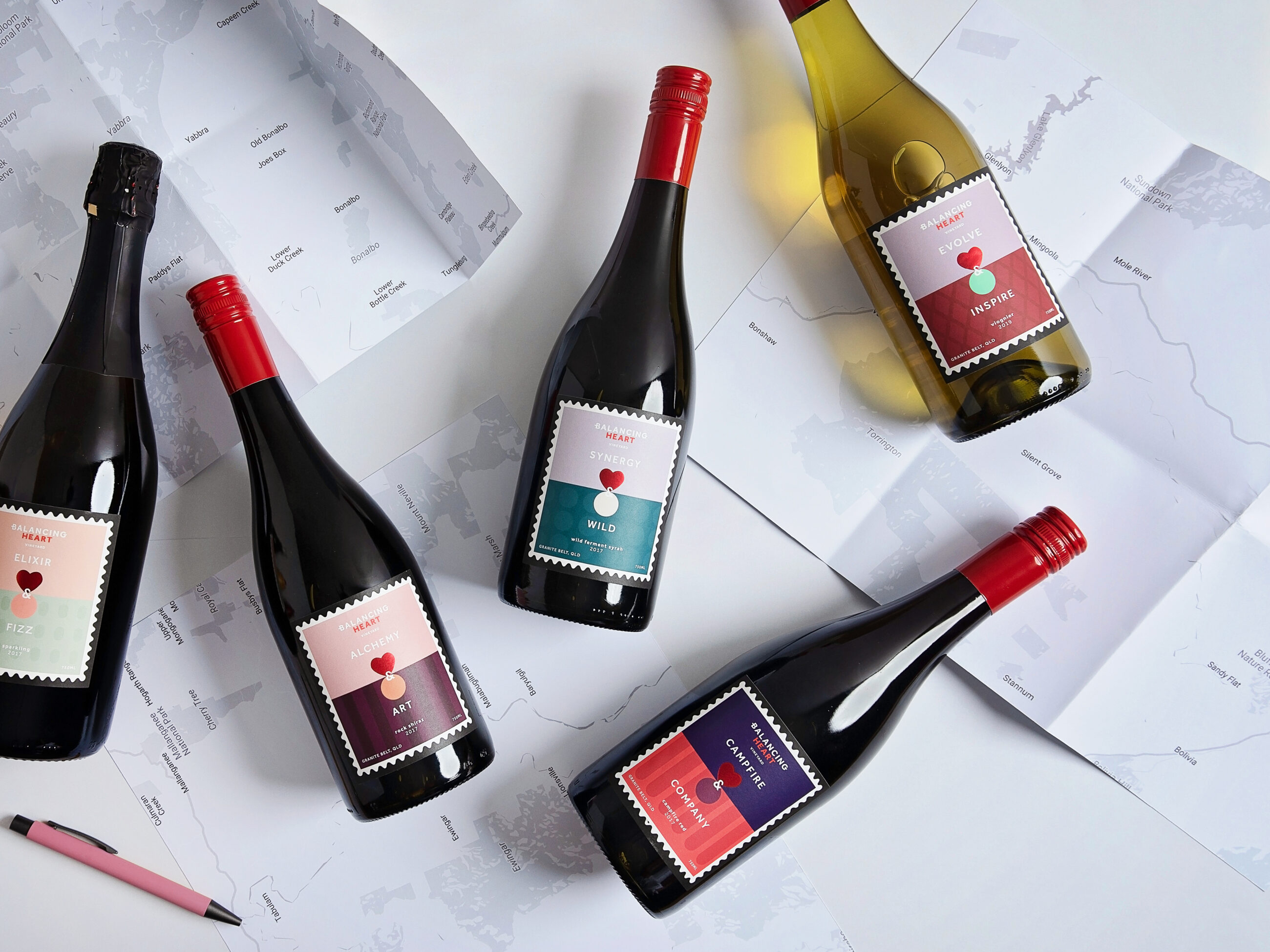 Bottles of Balancing Heart wine lying on a white table